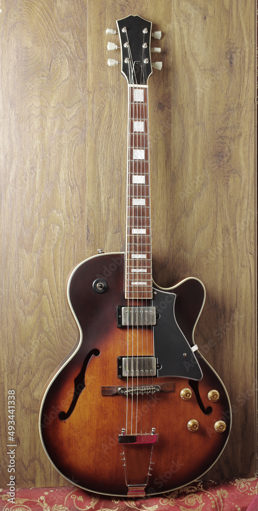 Fototapeta premium Jazz electro guitar on wooden texture background.