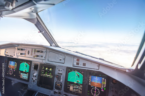 Interior view of the cockpit of a commercial airliner in flight. Pilots POV