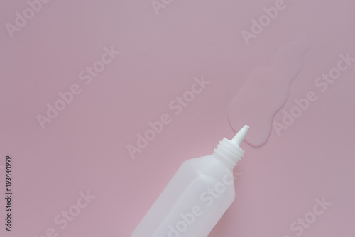 white medicine bottle on pink background