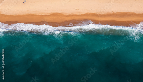 Aerial view of clear turquoise sea and sand beach