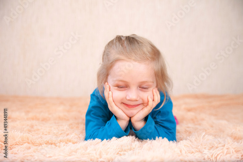Little three-year-old girl with   toy  on blanket