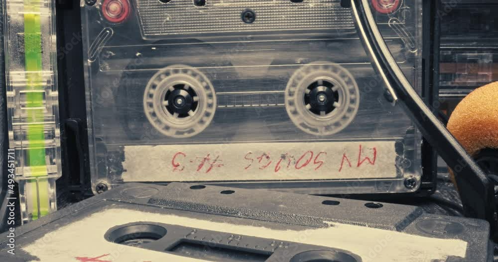 Old cassette and player. Player with spinning audio cassette.