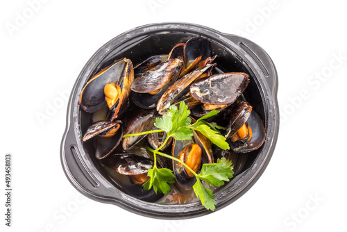 Mussels cooked with an Italian recipe called tarantina mussels in white, in a black plate with parsley isolated on white, top view, clipping path photo