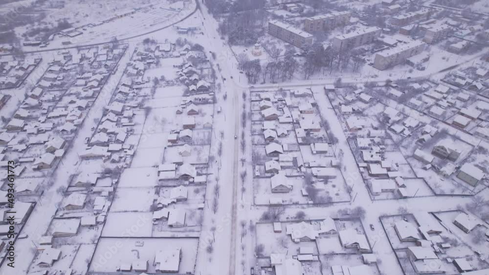 Aerial view of the ukrainian snow village with private houses and garden plots at winter time. Shooting from a drone. Ukraine, Eastern Europe Aerial view of the ukrainian snow village with private houses and garden plots at winter time. Shooting from a drone. Ukraine, Eastern Europe