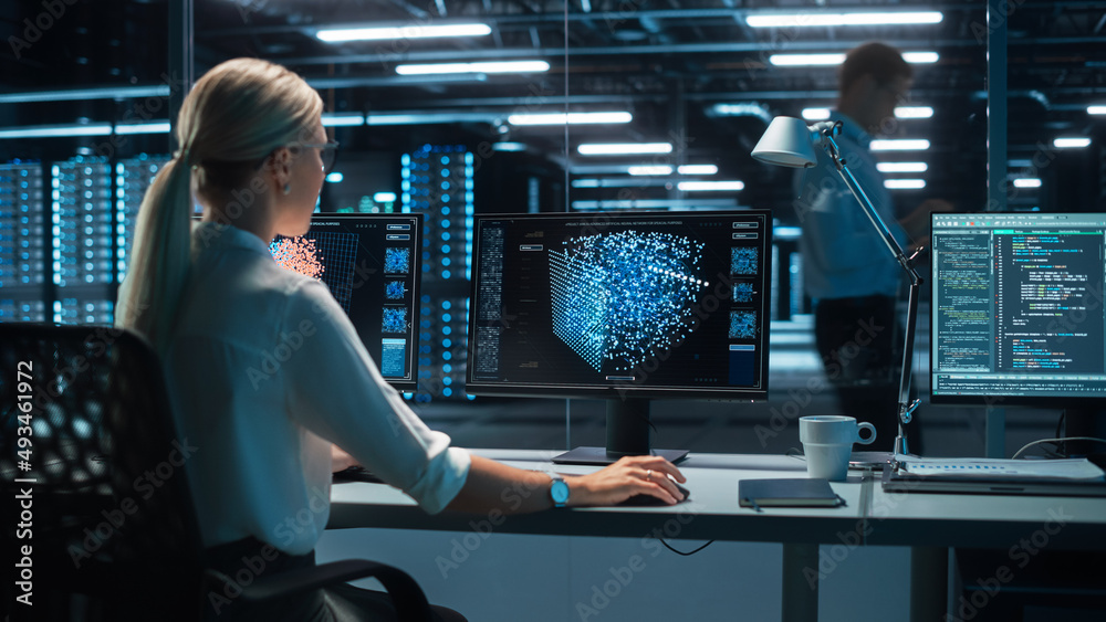 Confident Female Data Scientist Works on Personal Computer with Green Screen Template in Big Control and Monitoring Room. Ambitious Programming Engineer Using Chroma Key to Write Code in Office Room. Confident Female Data Scientist Works on Personal Computer with Green Screen Template in Big Control and Monitoring Room. Ambitious Programming Engineer Using Chroma Key to Write Code in Office Room.