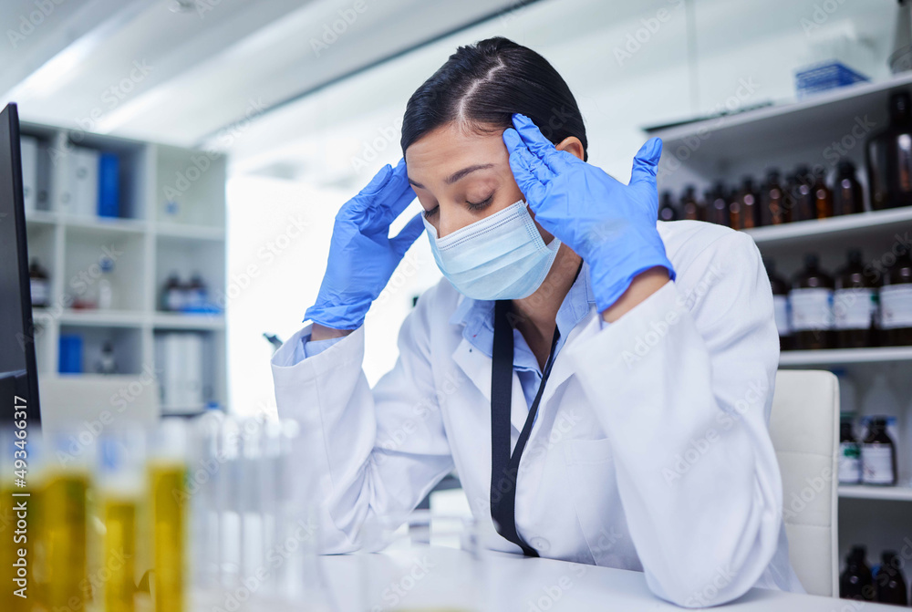 Headaches can ruin your entire day. Shot of a young female researcher working in a laboratory. Headaches can ruin your entire day. Shot of a young female researcher working in a laboratory.