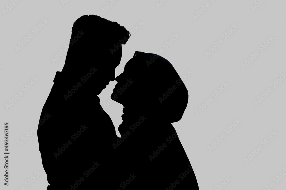 Silhouette image of romantic muslim couple. Isolated on gray background Silhouette image of romantic muslim couple. Isolated on gray background