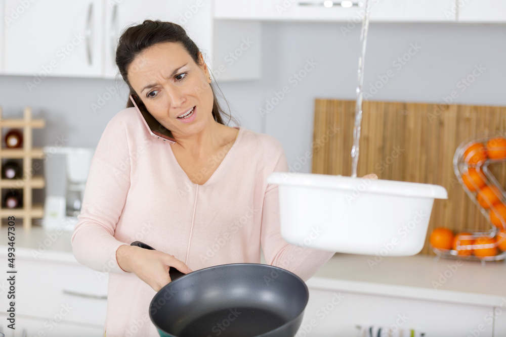 woman on the phone about leaking problem woman on the phone about leaking problem