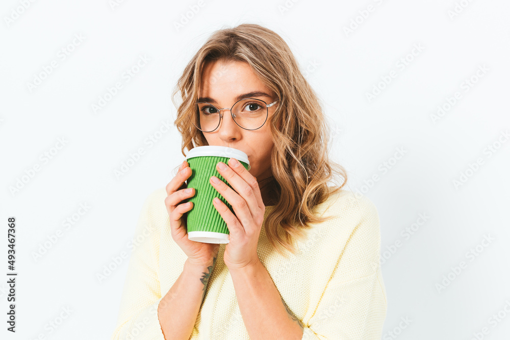 Portrait young woman drinking takeaway coffee