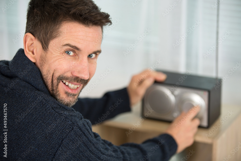 happy man with a new radio at home happy man with a new radio at home