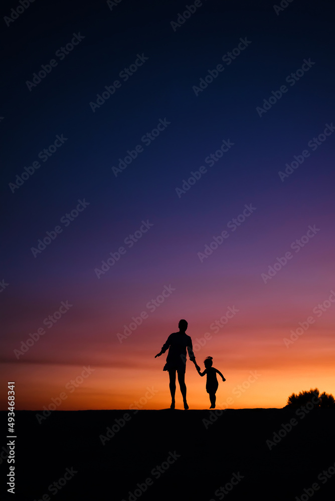 Mother with baby during sunset.