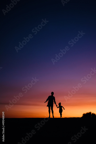 Mother with baby during sunset.