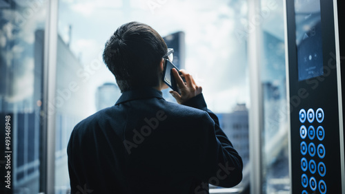 Photos Successful Stylish Japanese Businessman Riding Glass Elevator to Office in Modern Business Center