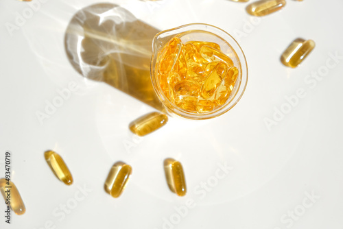 Fish oil gelatin capsules in laboratory flasks on a white background.Healthy eating and food supplements.omega fatty acids.