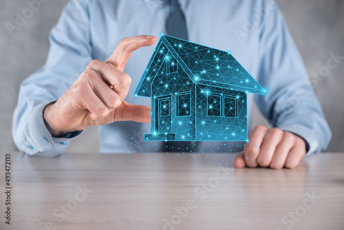 Man hold low polygon.Real estate concept, businessman holding a house icon.House on Hand.Property insurance and security concept. Protecting gesture of man and symbol of house