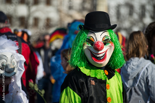 Basel - Switzerland - 9 March 2022 - portrait of masked people wearing traditional costumes of clown parading in the street