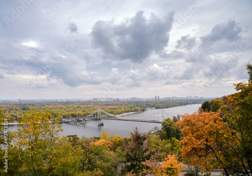 Autumn landscape of Kyiv. Colorful trees under a dramatic cloudy sky