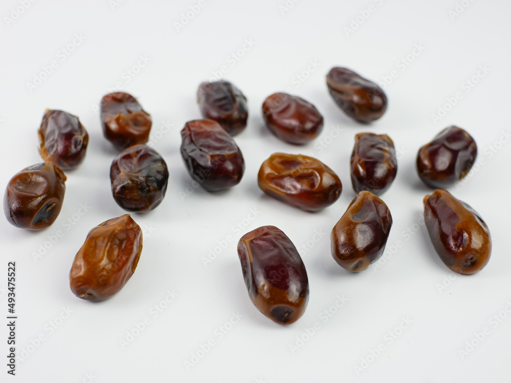 dates scattered isolated on a white background. healthy fruit ramadan concept dates scattered isolated on a white background. healthy fruit ramadan concept