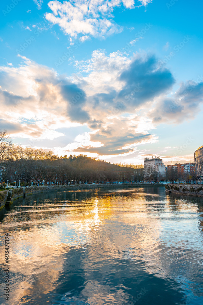 Sunset with clouds in the Uremea River of San Sebastian, tourist city a spring morning. Gipuzkoa, Basque Country