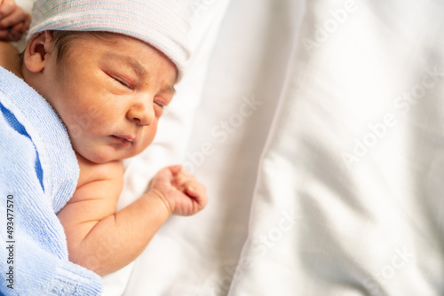 Newborn boy in the hospital, first day of life, asleep resting, copy space and paste