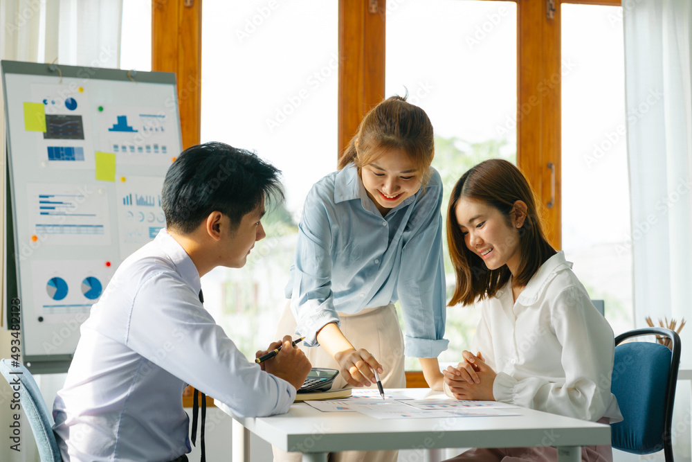 Fototapeta premium Asian business partners discussing documents and ideas at meeting.