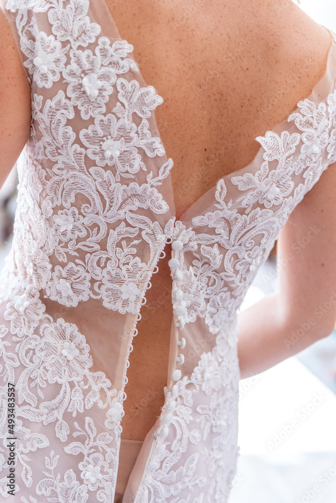 March 2022, bride photographed from behind wearing a loose dress