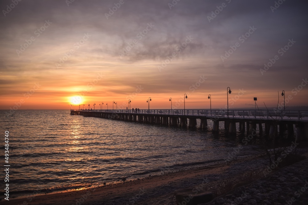 Colorful seaside morning landscape. Wooden pier on the sea at sunrise.