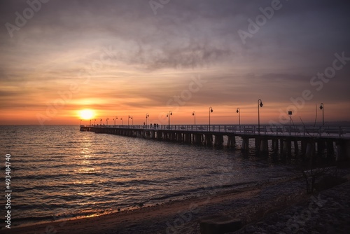 Colorful seaside morning landscape. Wooden pier on the sea at sunrise. © shadowmoon30