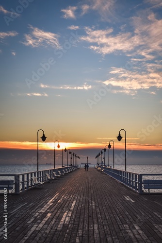 Beautiful morning seaside landscape. Wooden pier with a colorful sky in Gdynia Orlowo, Poland.