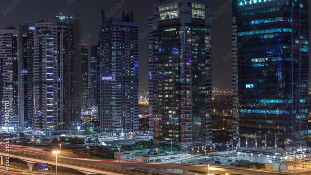 Aerial view of Jumeirah lakes towers skyscrapers night timelapse with traffic on sheikh zayed road. Aerial view of Jumeirah lakes towers skyscrapers night timelapse with traffic on sheikh zayed road.