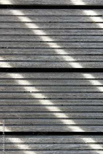 Sun rays create a pattern of lines on the wooden floor