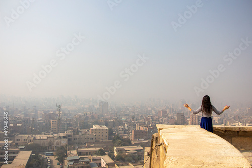 Woman looks at Cairo city, Egypt