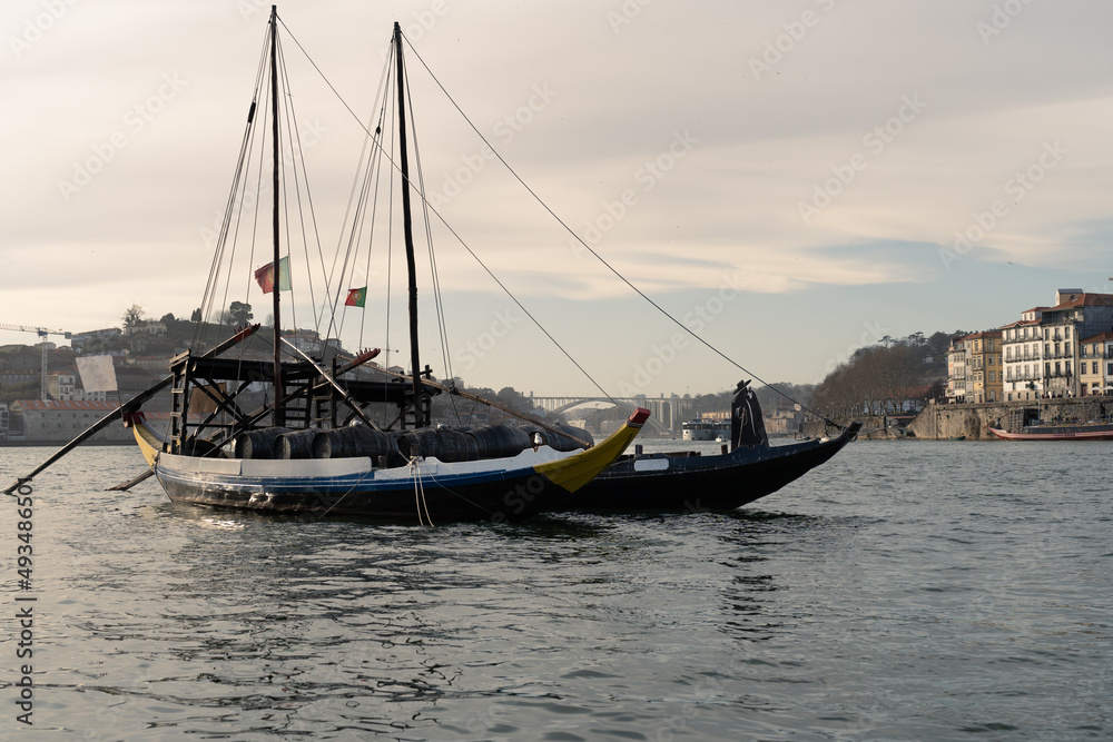 Rabelo boat on the Douro river with the city of Porto in the background.