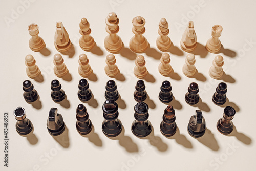 Chess game black and white ready to fight on a beige background. Minimal victory and success competition concept.