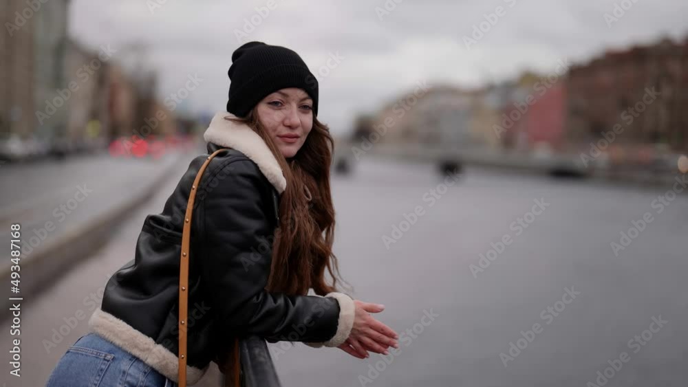 Pretty woman, on a city street near the river. Close-up of a girl on a city background. A woman of natural beauty enjoying an evening outdoors. Pretty woman, on a city street near the river. Close-up of a girl on a city background. A woman of natural beauty enjoying an evening outdoors.