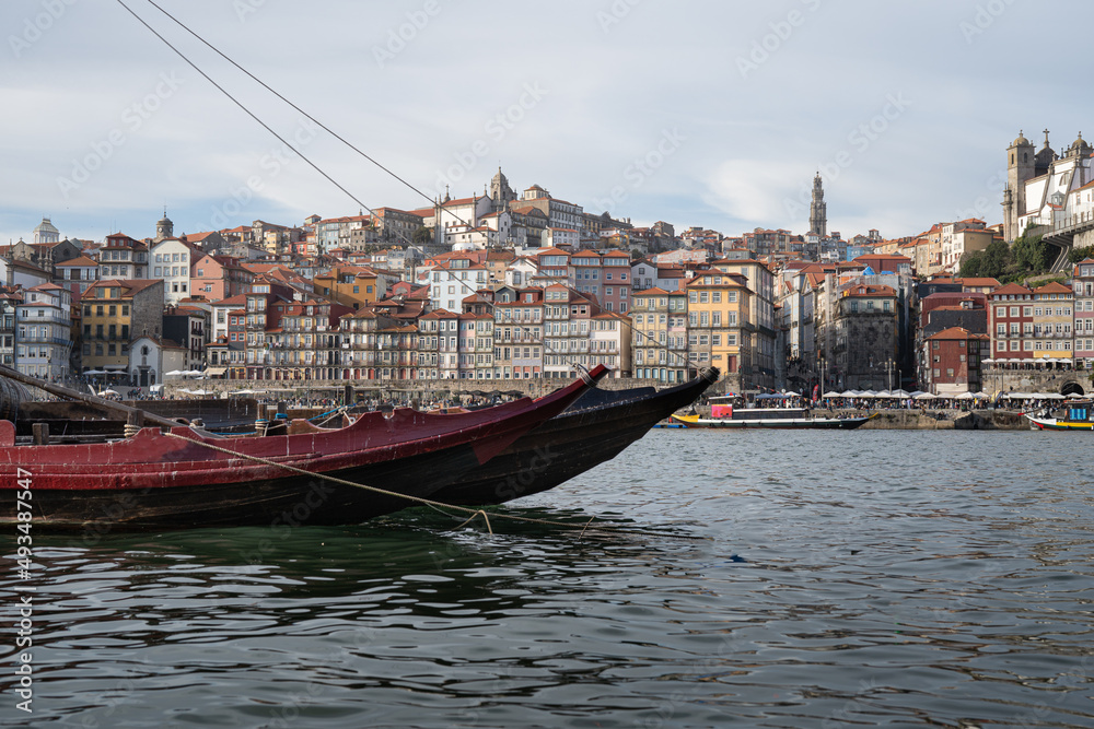Rabelo boat on the Douro river with the city of Porto in the background.