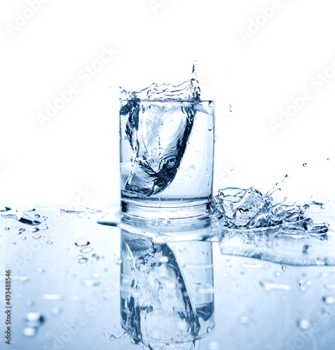 Drinking water splashed with ice in glass photo