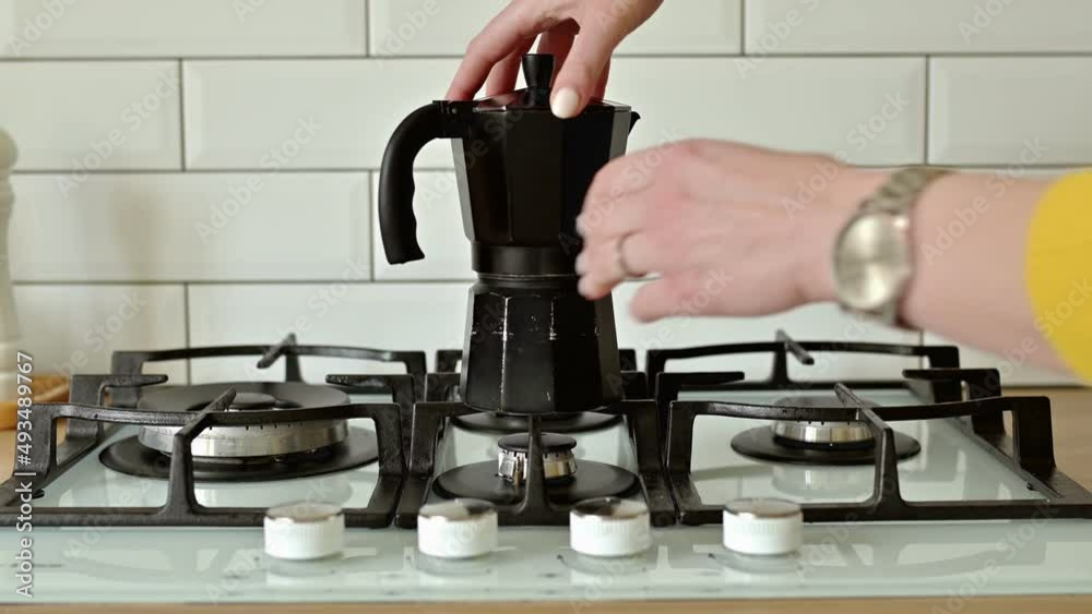 Put a geyser coffee maker on a gas stove to make coffee at home close up with artificial blue light. Morning daily home routine