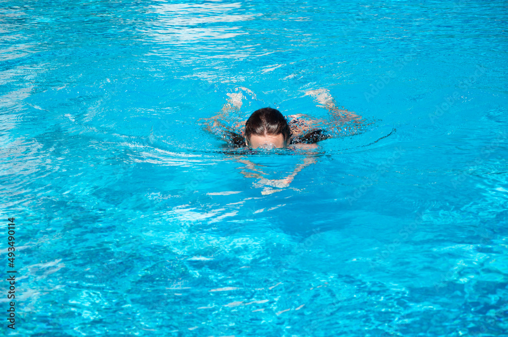 woman swim in the swimming pool water. summer vacation and activity