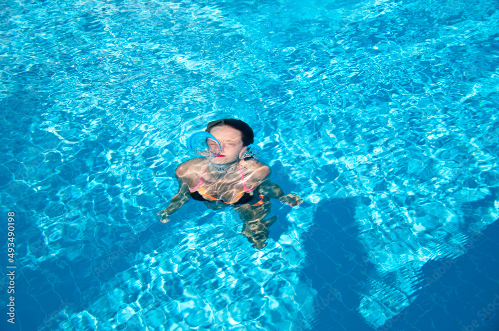 woman swimming under blue sea water. summer vacation. underwater