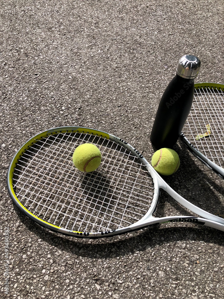 Photo of tennis ball, racket and water bottle