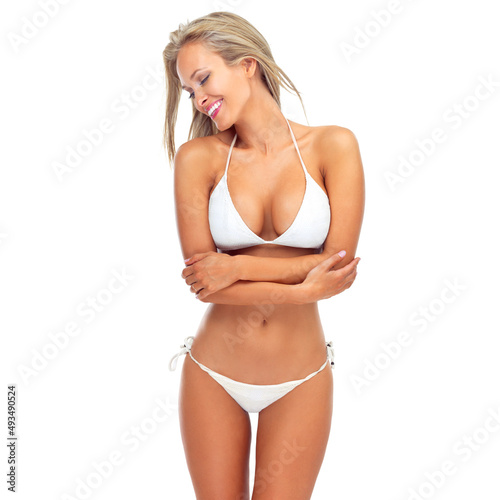 Show off that summer body. Studio shot of a sexy young woman smiling while posing in a bikini against a white background. © Yuri A/peopleimages.com