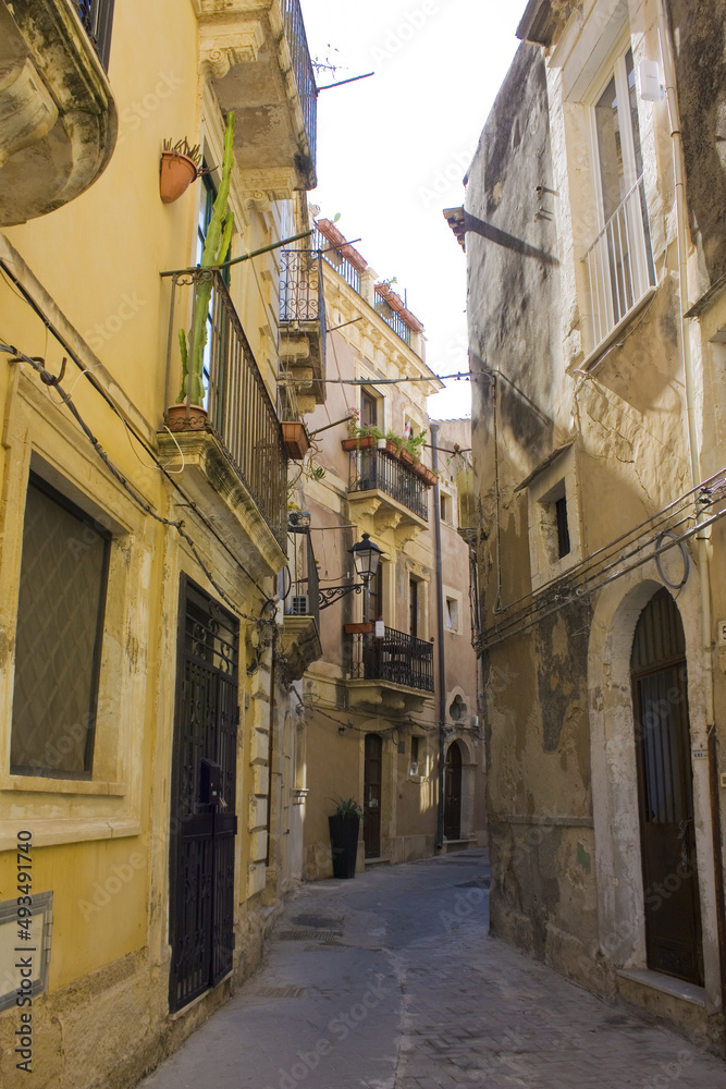 Narrow and picturesque street on Ortigia Island in Siracusa, Sicily, Italy