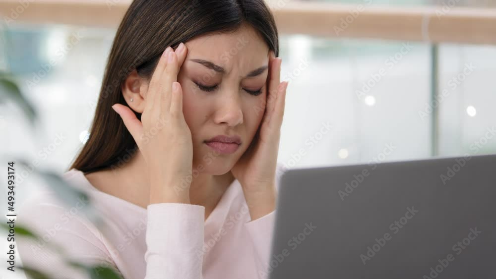 Close up headshot Asian korean lady sick ill chinese girl stressful business woman feeling headache pain tired exhausted worker female student with laptop suffering discomfort head tension stress Close up headshot Asian korean lady sick ill chinese girl stressful business woman feeling headache pain tired exhausted worker female student with laptop suffering discomfort head tension stress