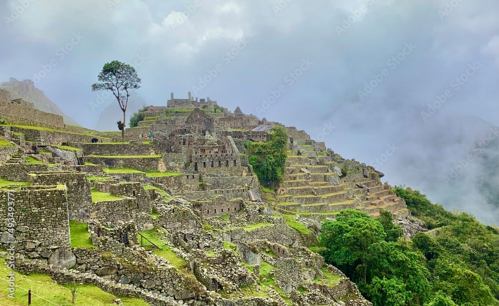 ruins of the ancient city of machu picchu with foggy