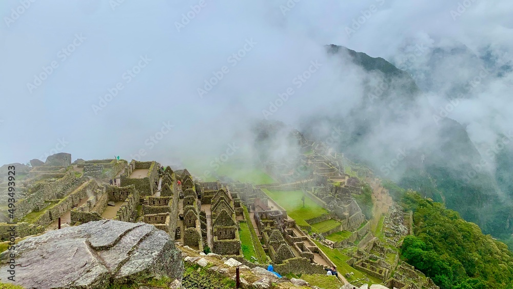 morning in the mountains from machu picchu with fog in the background
