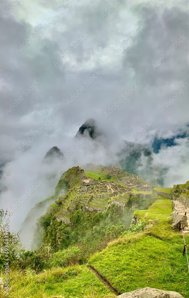 clouds over the mountains from machu picchu with the ruins of the ancient city with foggy clouds over the mountains from machu picchu with the ruins of the ancient city with foggy