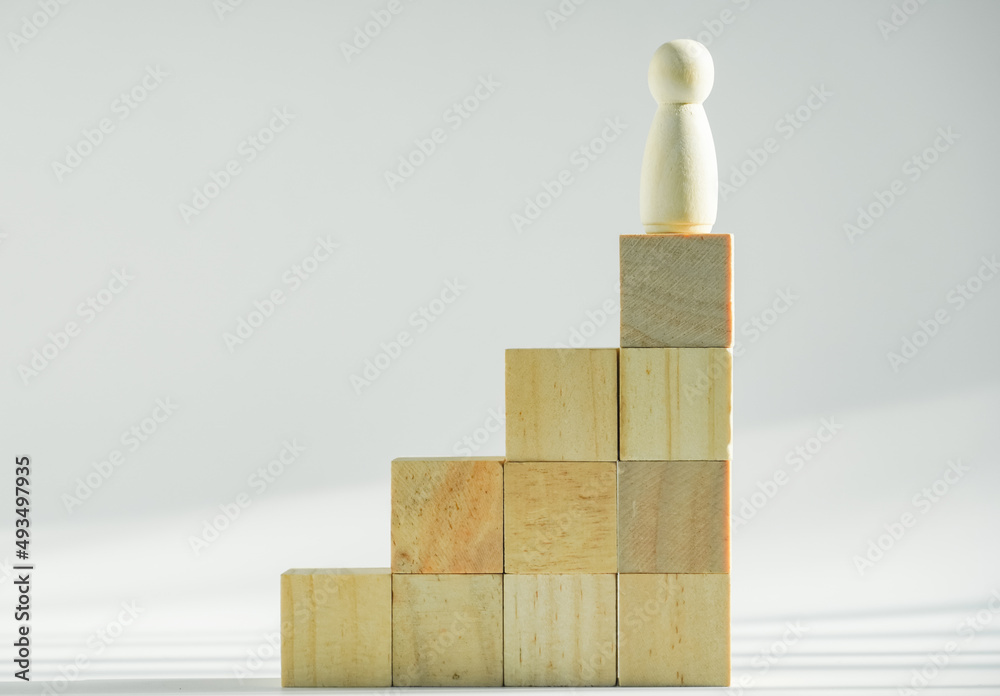 Concept fo growing business and success process, symbol of winner from  wood block stacking on white background, copy space.