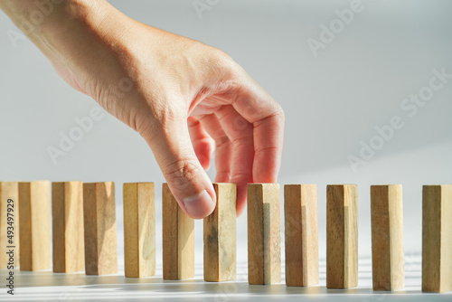 Concept fo growing business and success process, people hand holding wood block stacking on white background, copy space.