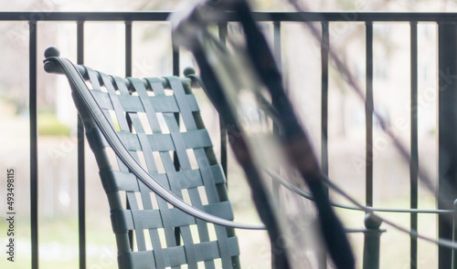 Black plastic outdoor patio chairs give off a vibe through screen door